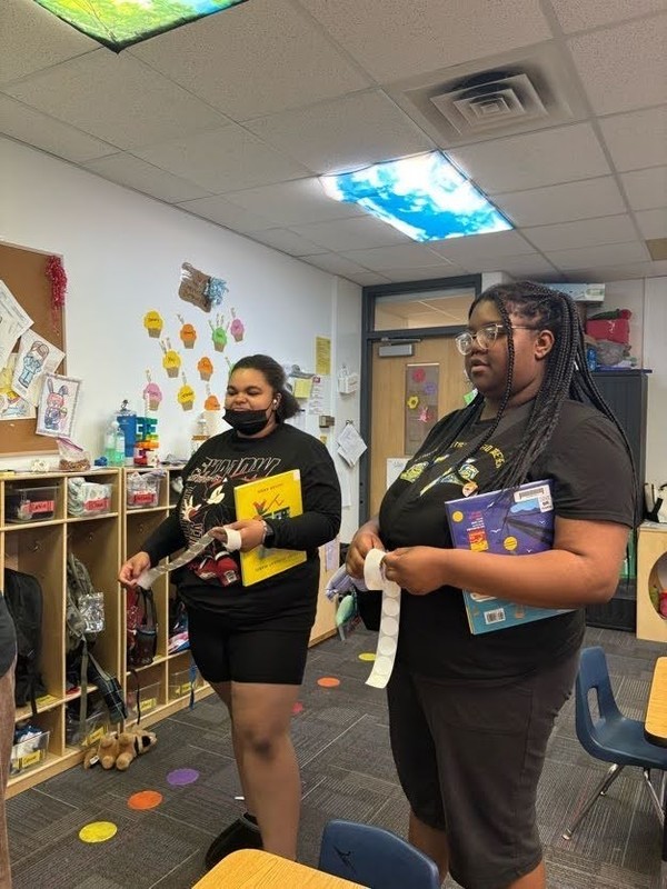 Two girls holding picture books