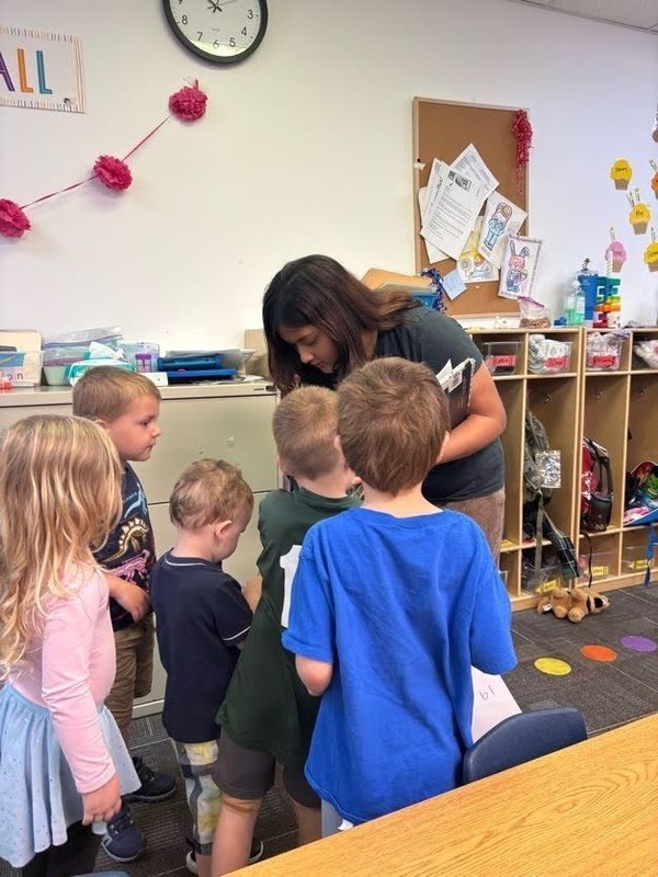 Student gives children stickers