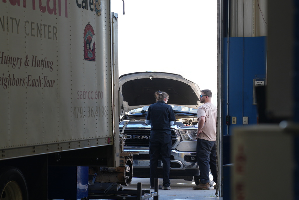 Students repairing pickup truck
