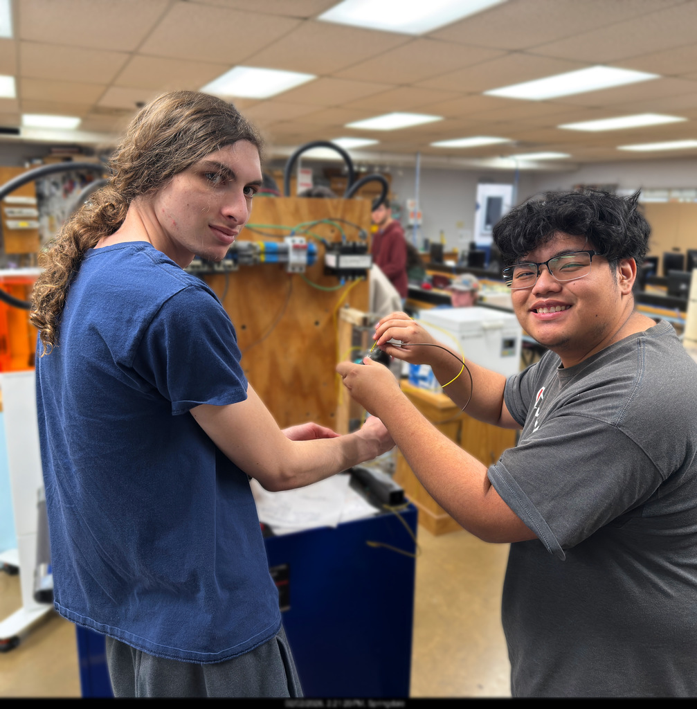 NWTI electronics and automation students work on a 3 phase motor control