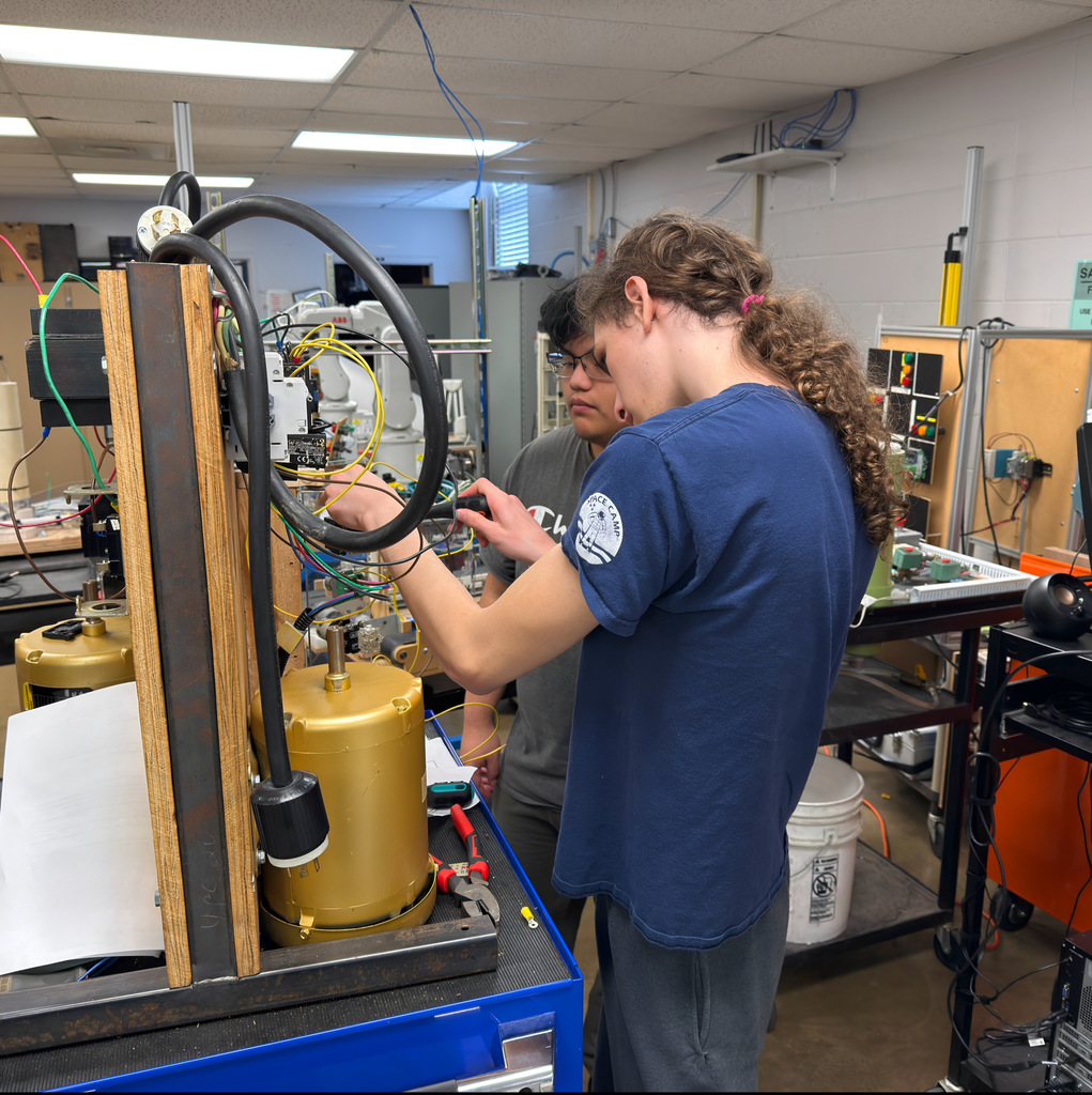 NWTI electronics and automation students work on a 3 phase motor control