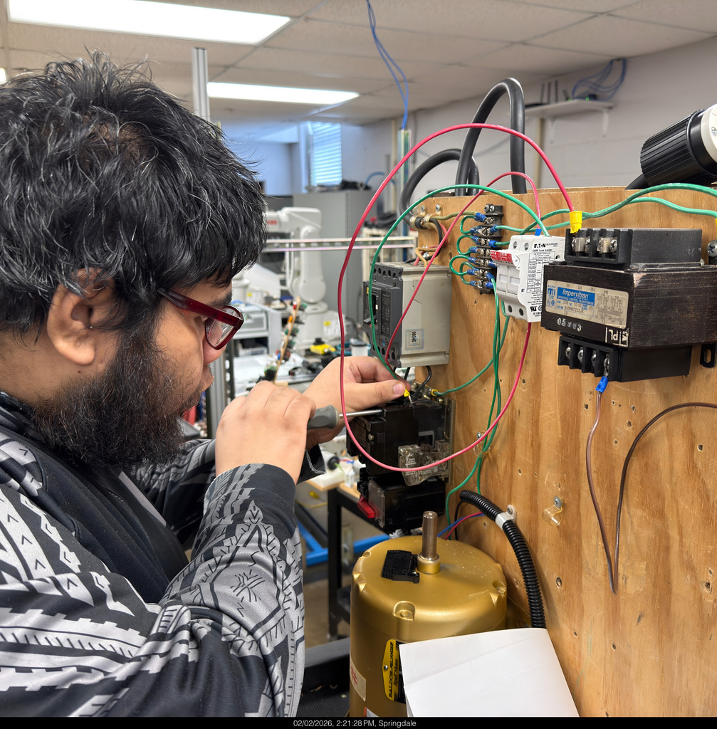 NWTI electronics and automation students work on a 3 phase motor control