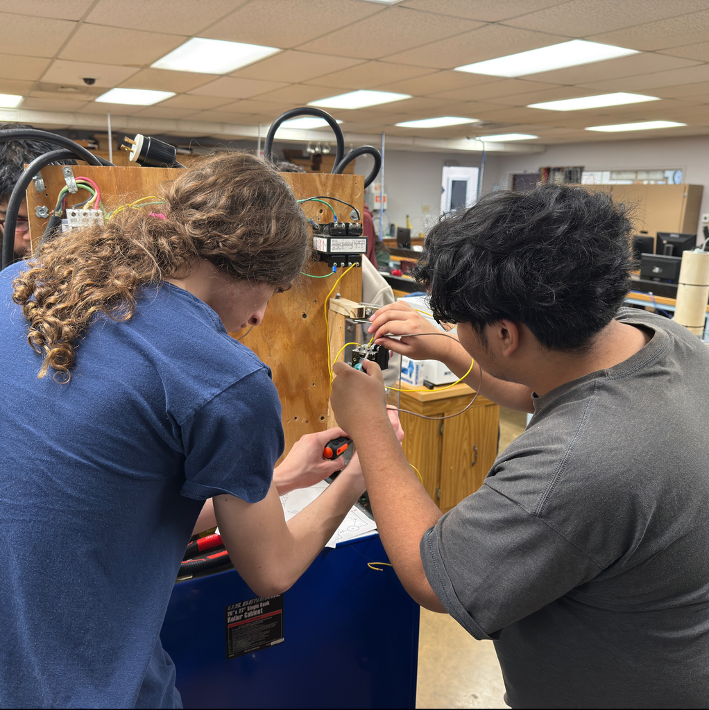 NWTI electronics and automation students work on a 3 phase motor control