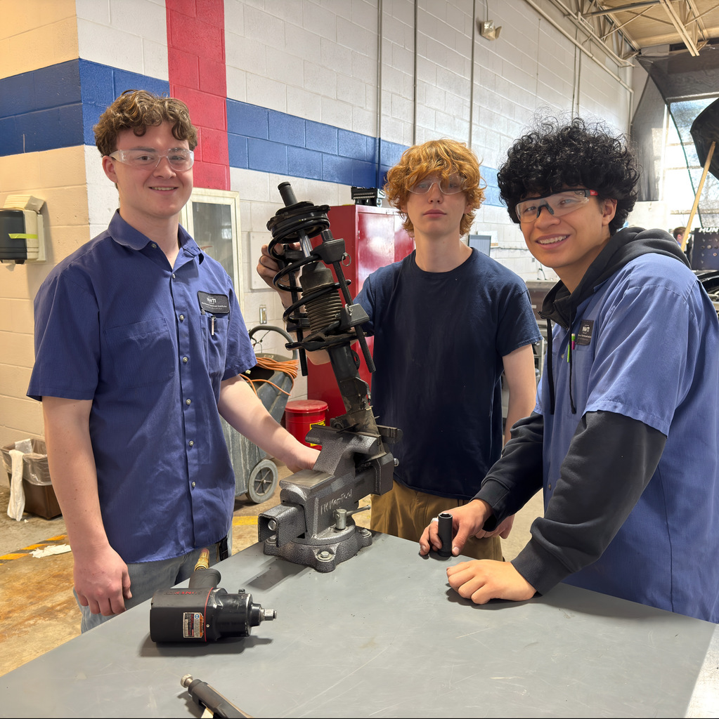 Our high school automotive program students work on a strut coil