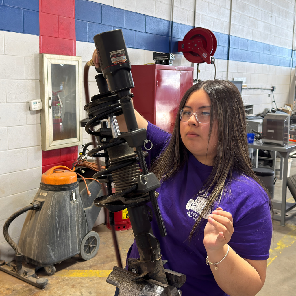 Our high school automotive program students work on a strut coil