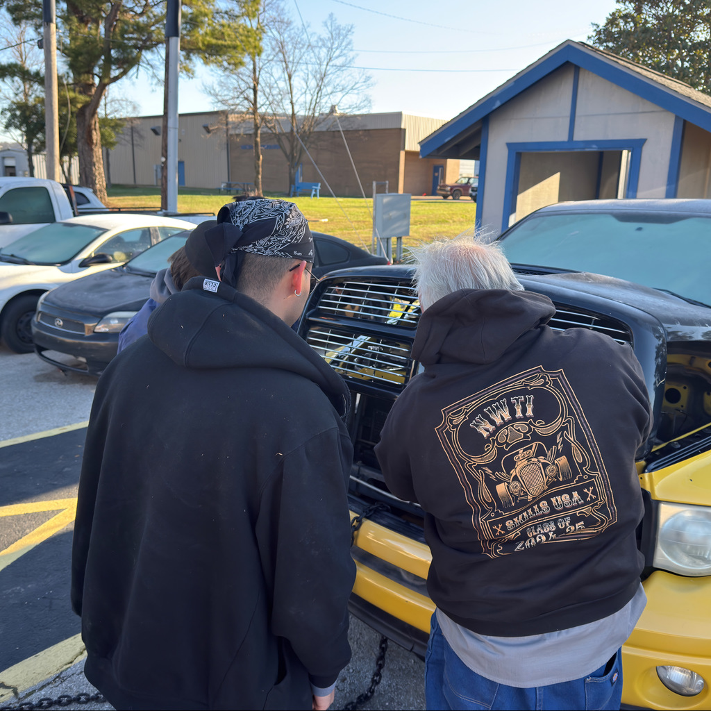 john lindsey and 3 automotive students prepare the pick-up truck for today's demolition