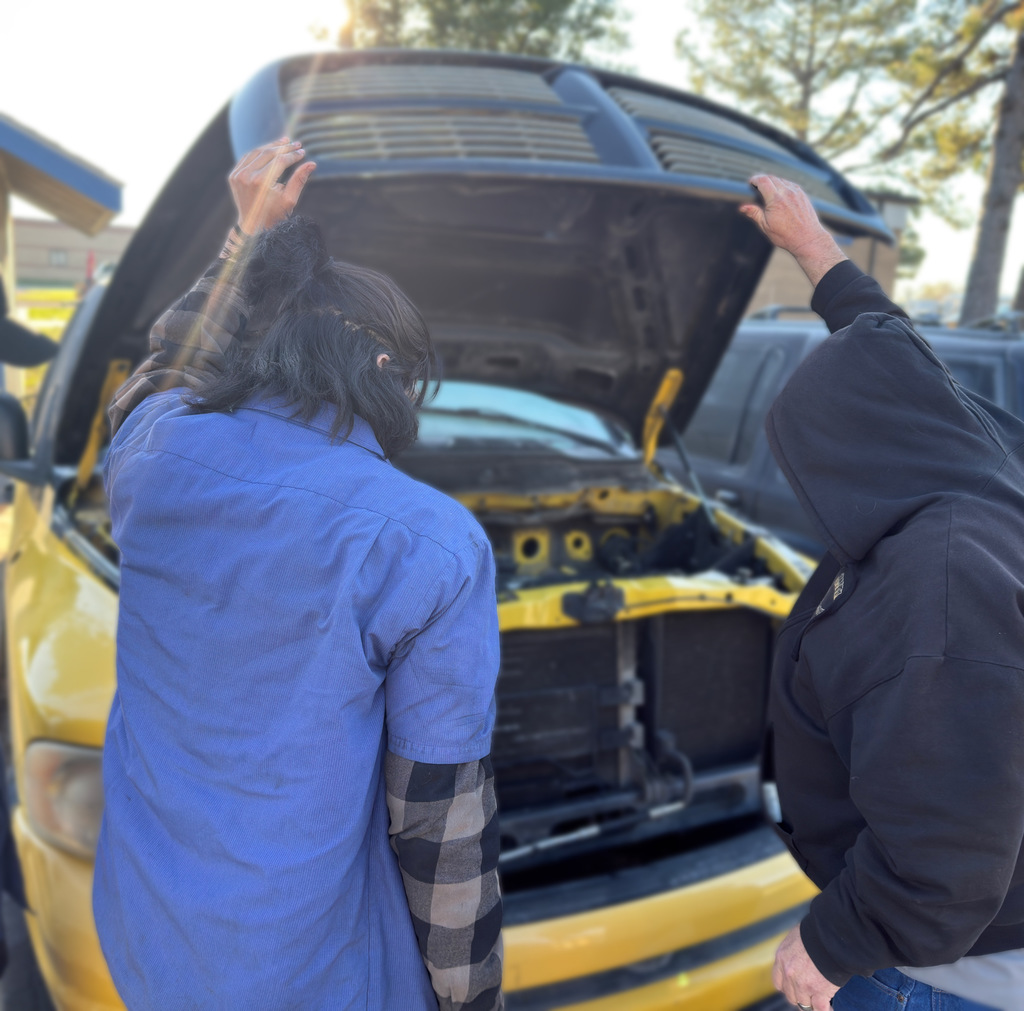 john lindsey and 3 automotive students prepare the pick-up truck for today's demolition