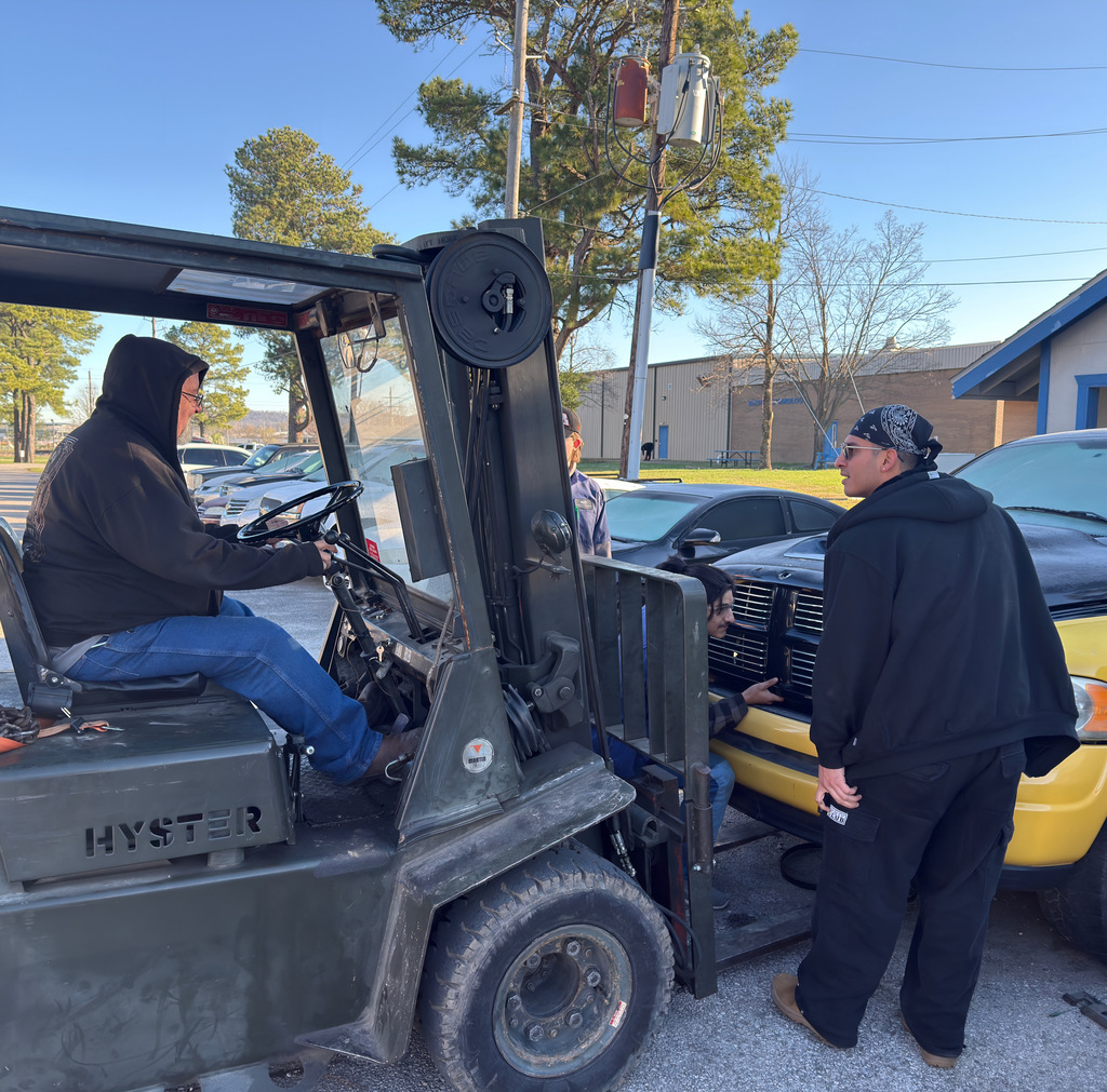 john lindsey and 3 automotive students prepare the pick-up truck for today's demolition