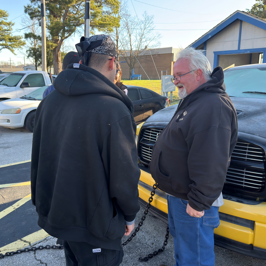 john lindsey and 3 automotive students prepare the pick-up truck for today's demolition