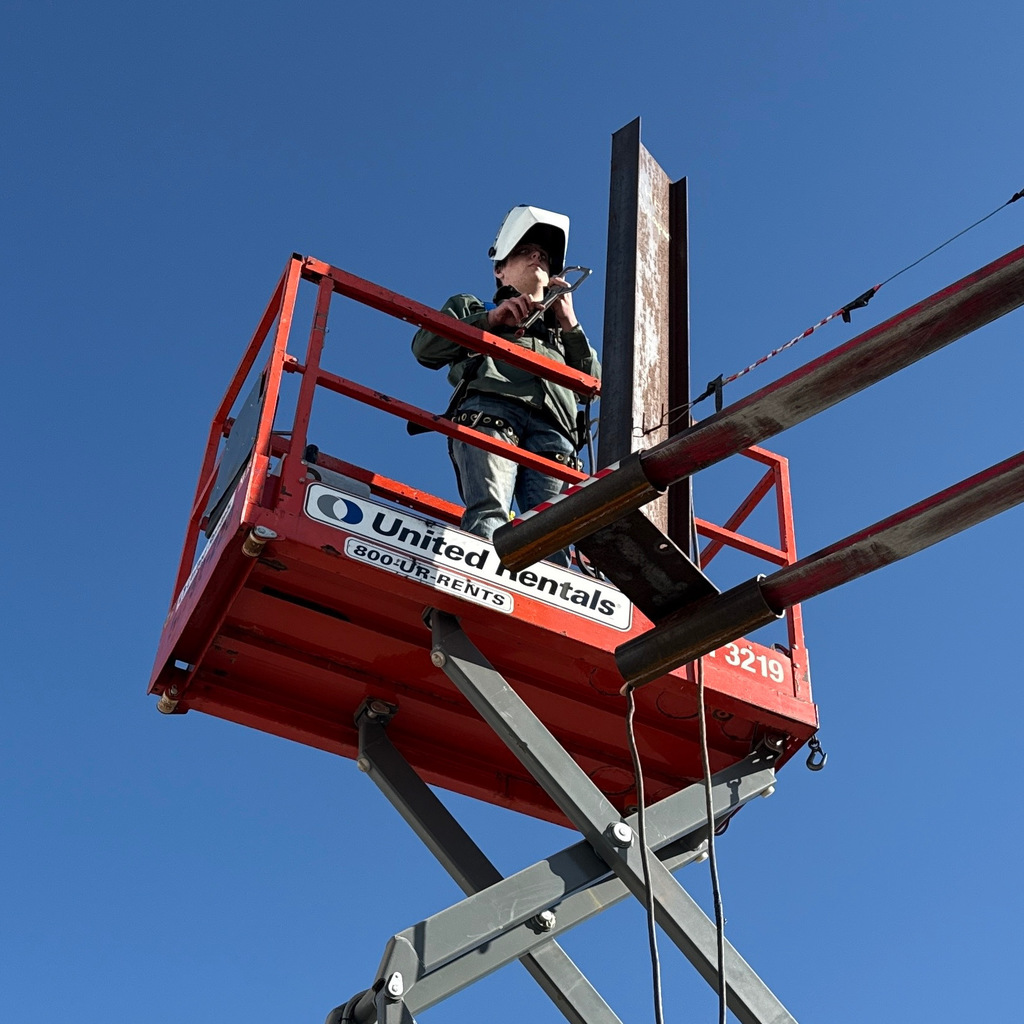 Welding students up on a crane
