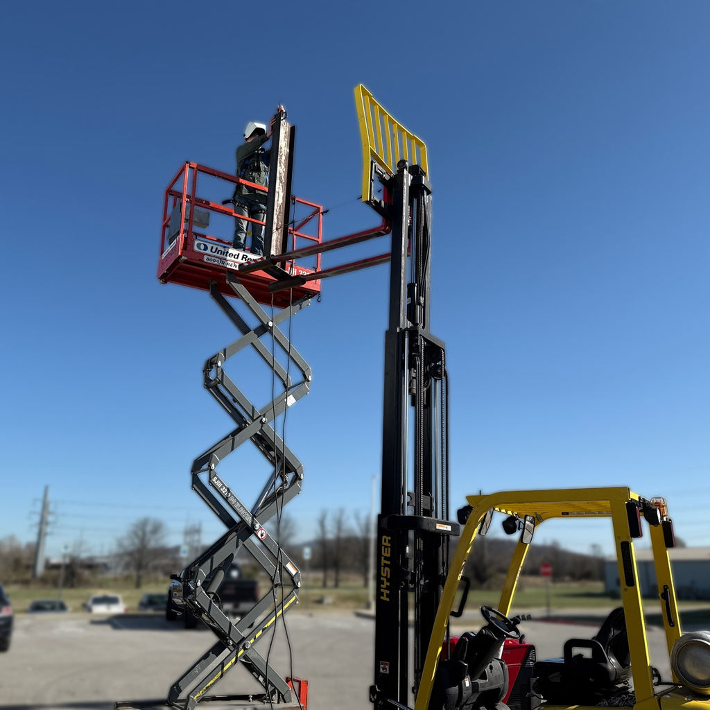 Welding students up on a crane