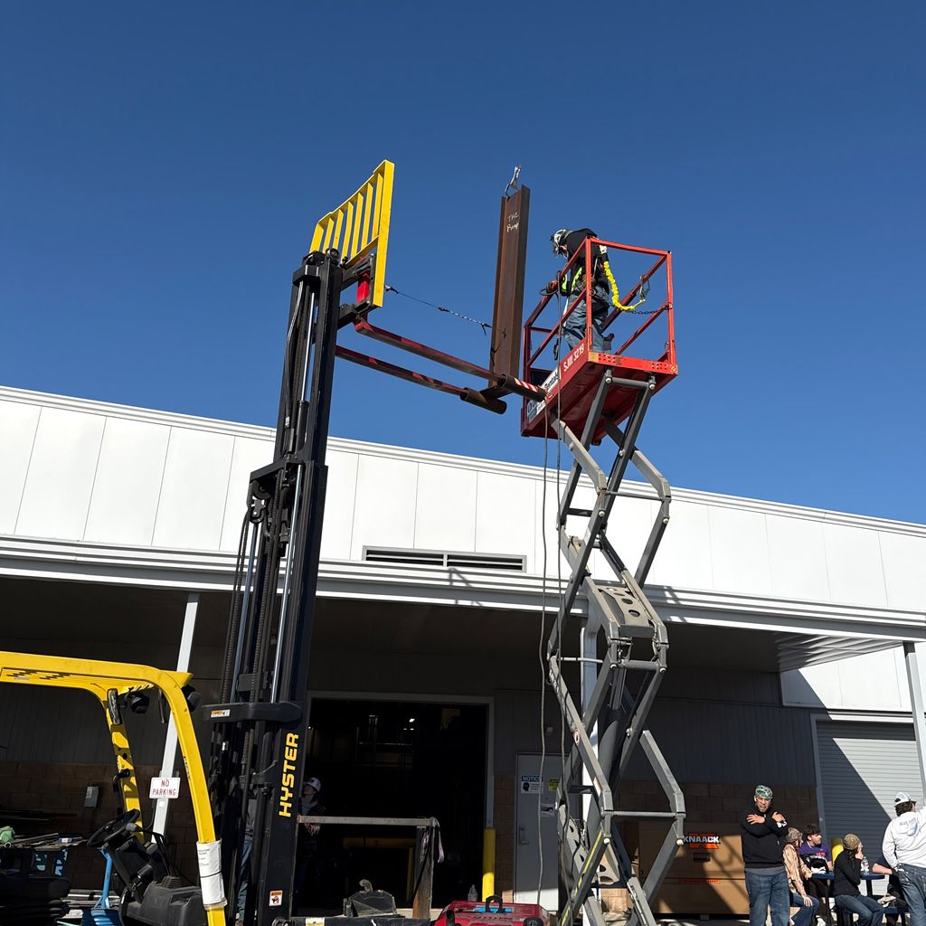 Welding students up on a crane