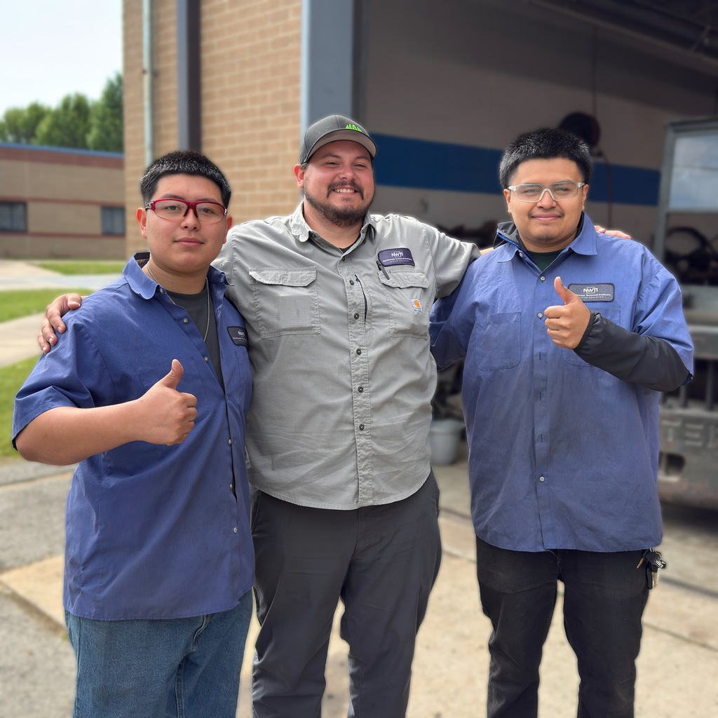 two automotive students pictured with instructor nate despain