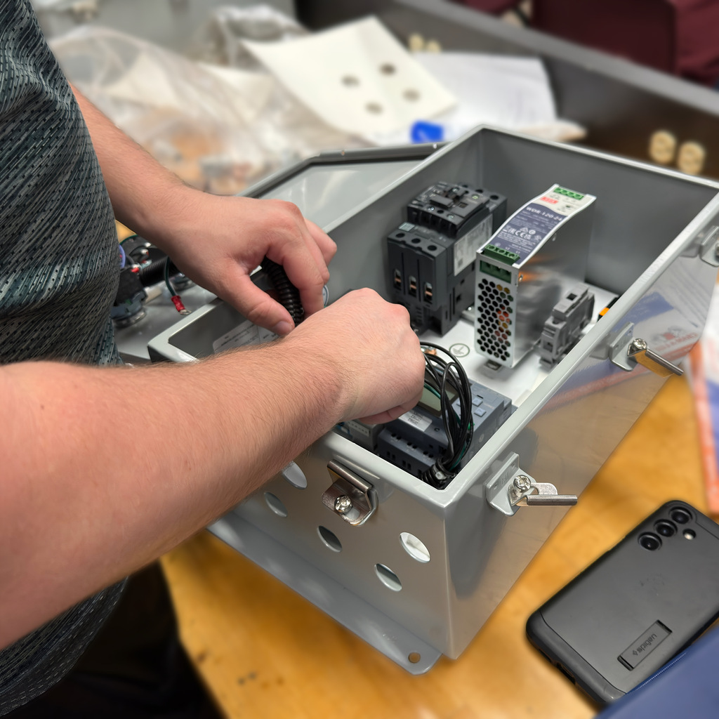 Electronics student Garrett Burger works on a control panel