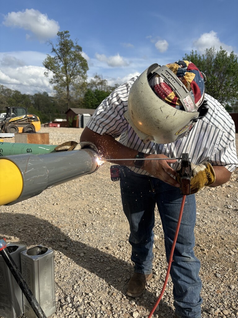 former NWTI student Jose Alvaro welding pipe on the job