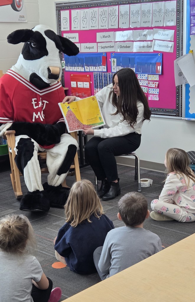 graphic of cow reading to students