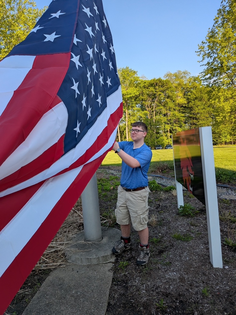 Student raising flag