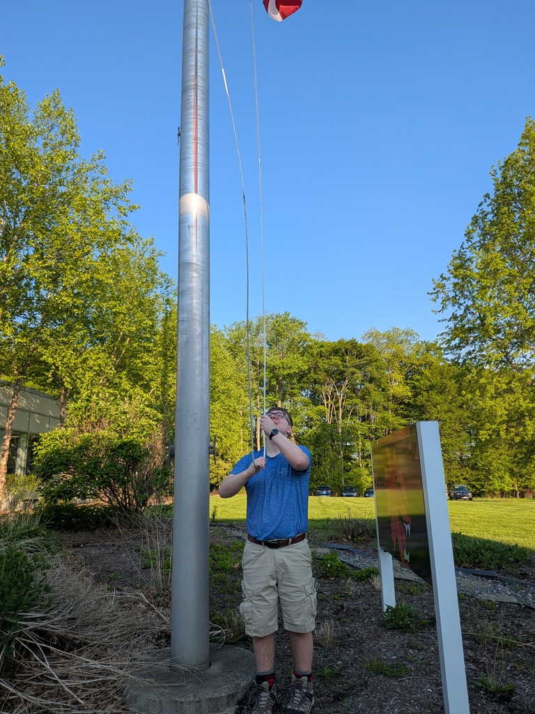 Student raising flag