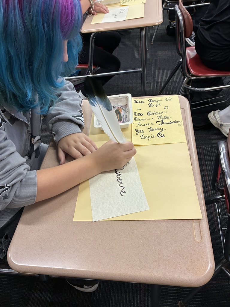Middle school students writing with quills