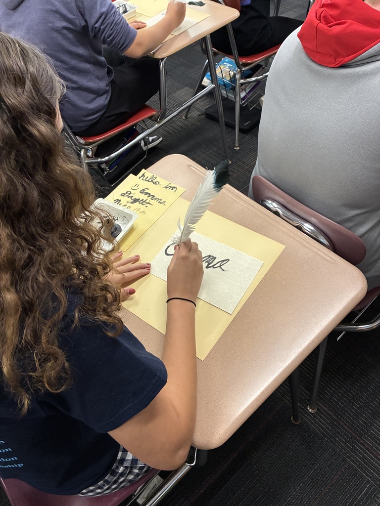 Middle school students writing with quills