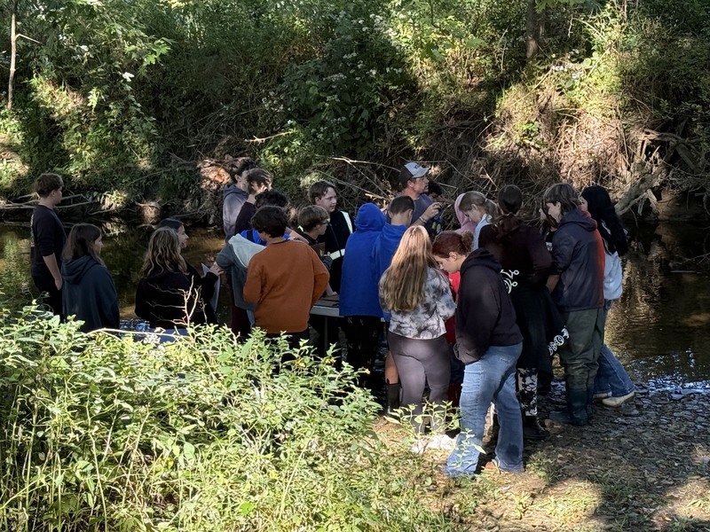 Middle school students exploring creek at Albion Boro Park