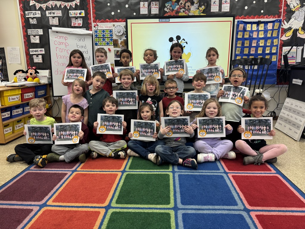 kids sitting on flor holding books