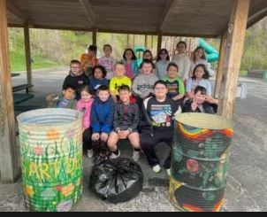 kids on bench around trash cans