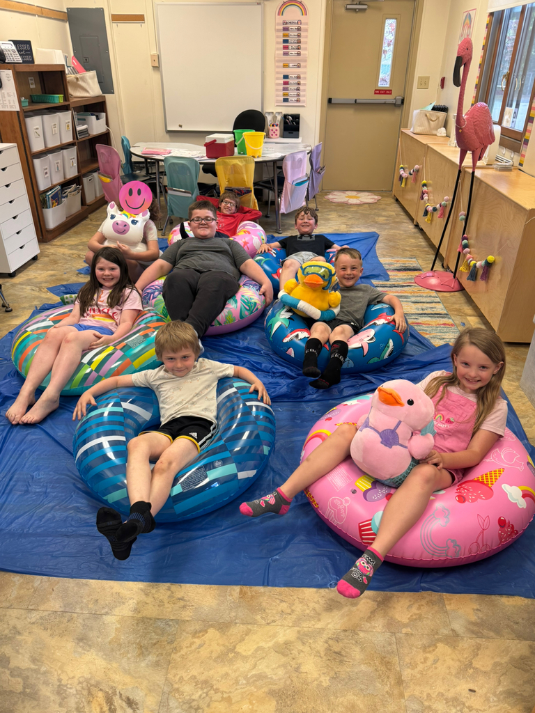 kids on pool floats reading