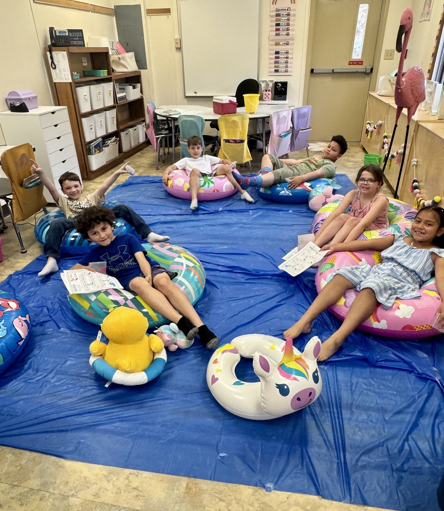 kids on pool floats reading