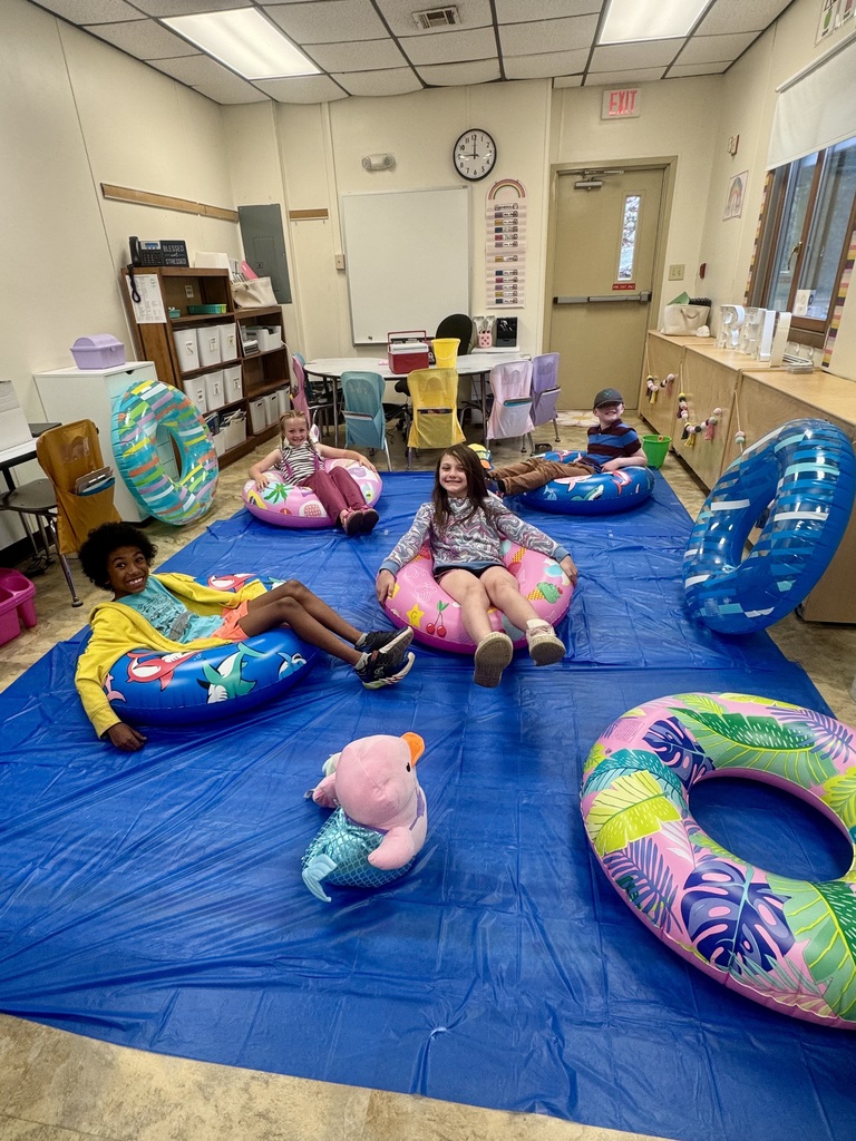 kids on pool floats reading