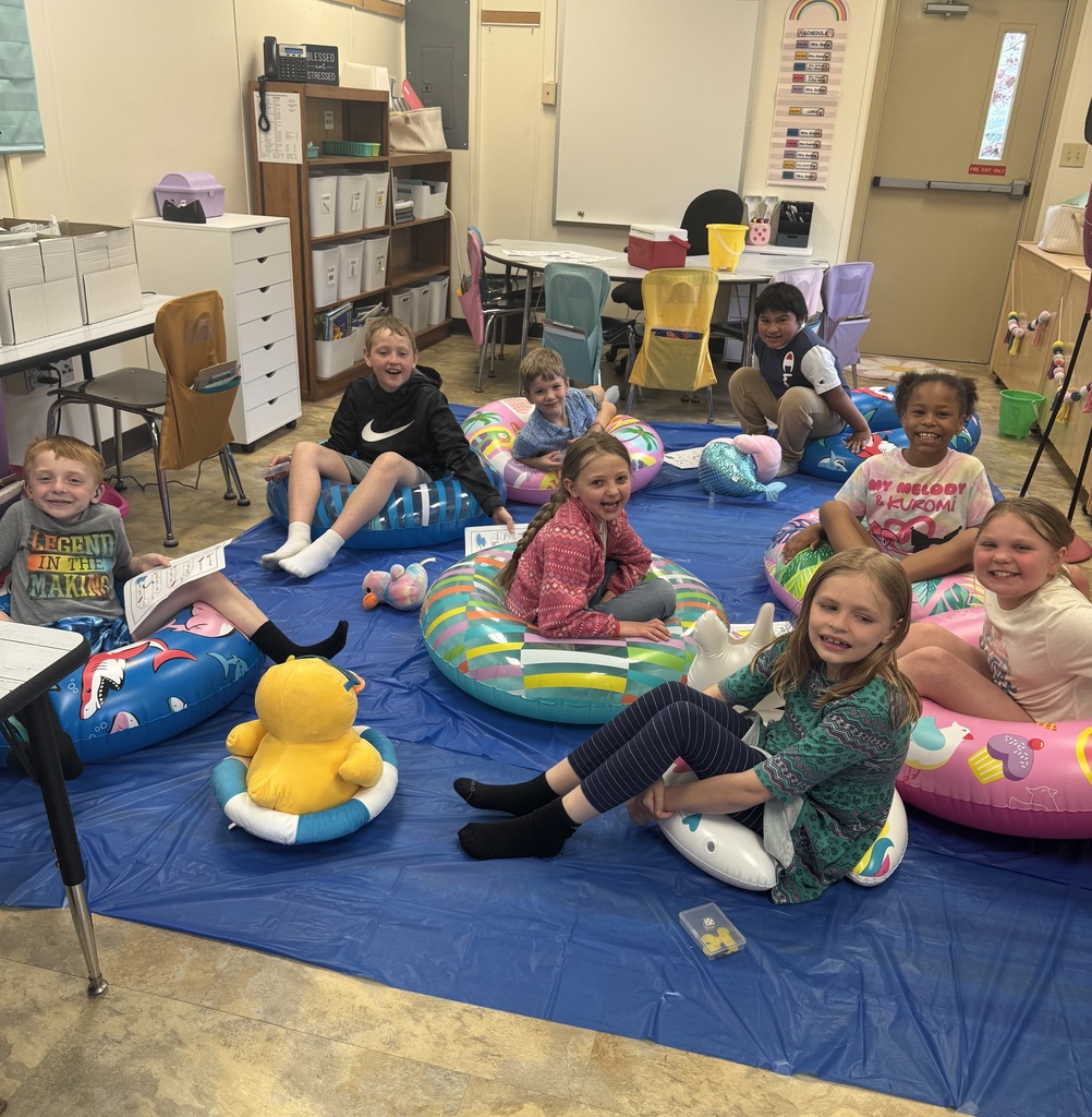 kids on pool floats reading