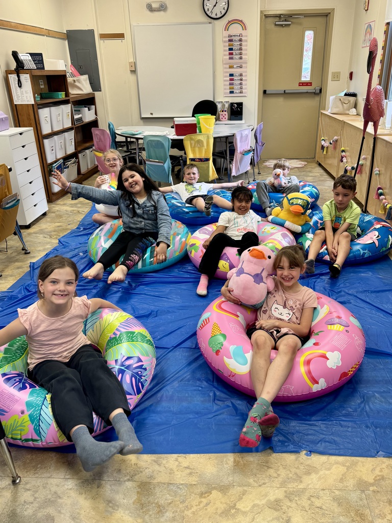 kids on pool floats reading