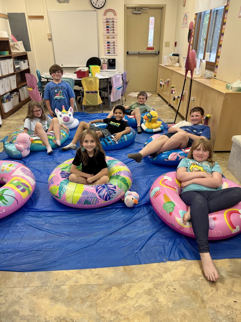 kids on pool floats reading