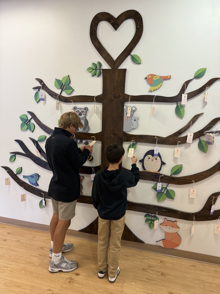 kids reading tags on wall