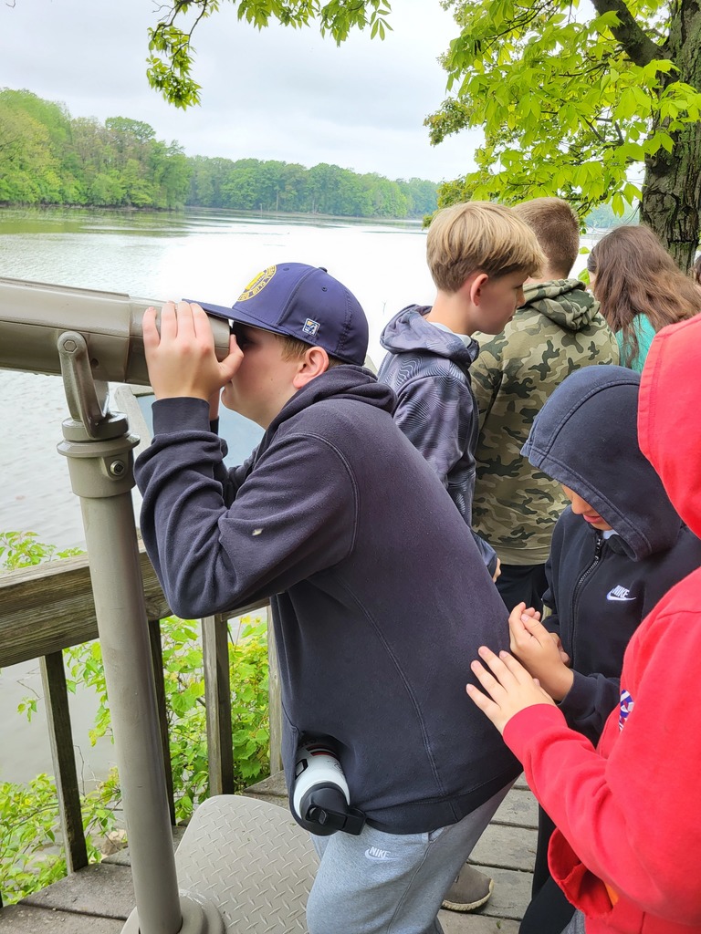 boy looking through telescope