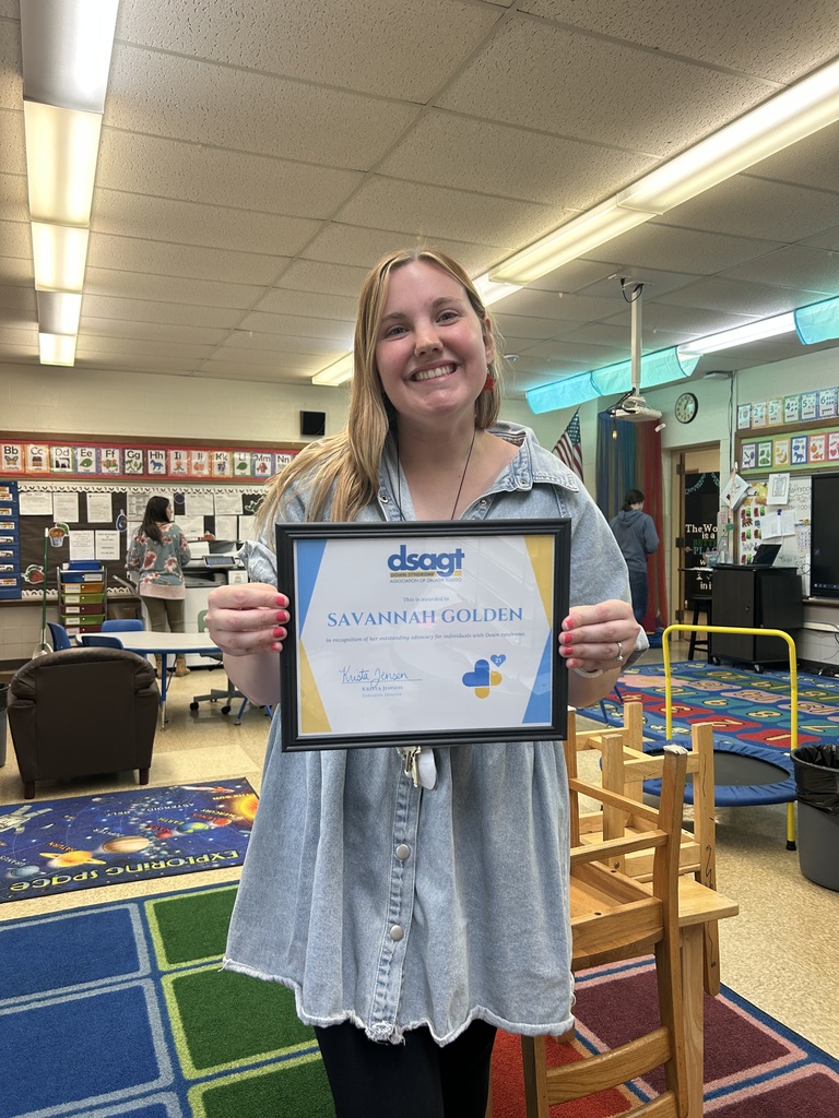 teacher with award