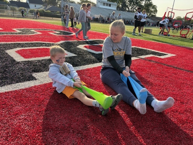 High School Cross Country and Track team doing stretches with the kids during Reading Under the Lights