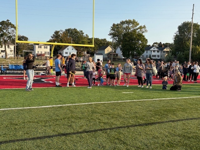 High School Cross Country and Track team doing stretches with the kids during Reading Under the Lights