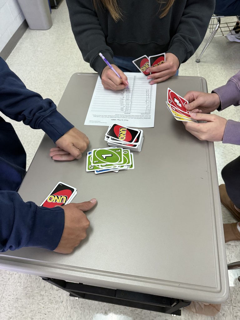 Today in Mrs. Kaple's Honors Geometry the students played UNO to get ready for Geometric Proofs. UNO is used to introduce proofs because it leverages a familiar game to teach abstract concepts by modeling them as a step-by-step puzzle with clear rules. Students can connect to the concept of a proof through the act of playing UNO cards to get from a "given" card to a "prove" card. The rules of UNO serve as the "postulates" or "reasons" for each step (card) in the sequence, helping students understand deductive reasoning and the logical justification required for a formal proof in a hands-on, engaging way.