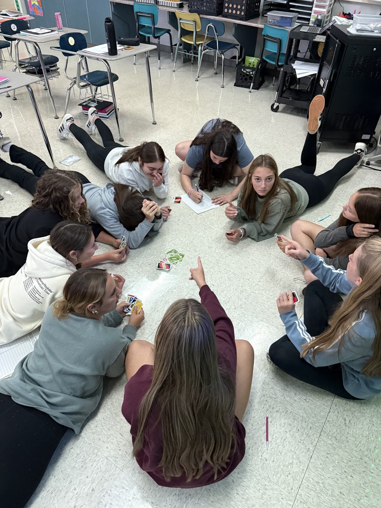 Today in Mrs. Kaple's Honors Geometry the students played UNO to get ready for Geometric Proofs. UNO is used to introduce proofs because it leverages a familiar game to teach abstract concepts by modeling them as a step-by-step puzzle with clear rules. Students can connect to the concept of a proof through the act of playing UNO cards to get from a "given" card to a "prove" card. The rules of UNO serve as the "postulates" or "reasons" for each step (card) in the sequence, helping students understand deductive reasoning and the logical justification required for a formal proof in a hands-on, engaging way.