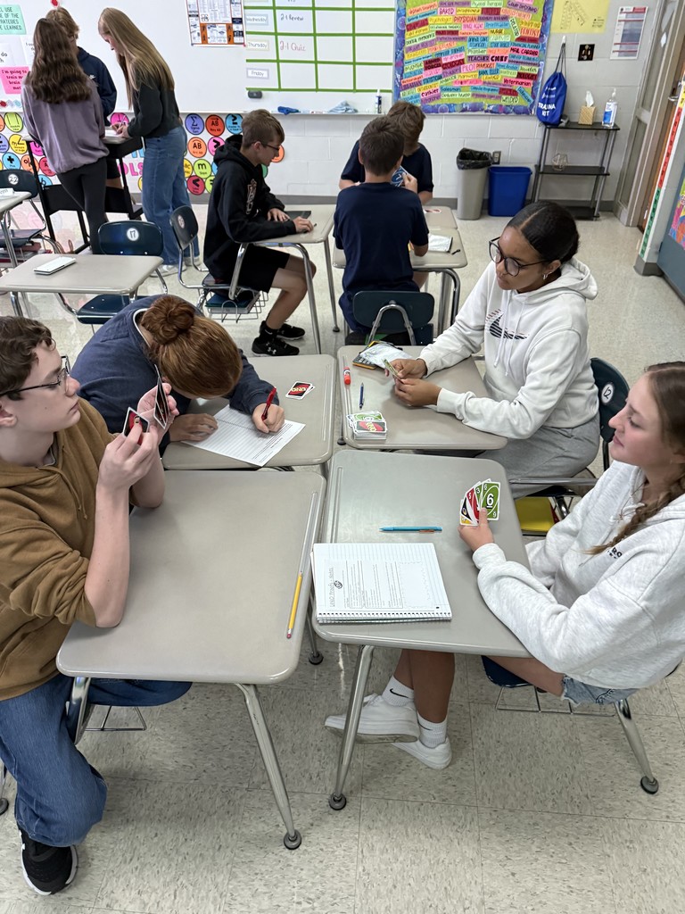 Today in Mrs. Kaple's Honors Geometry the students played UNO to get ready for Geometric Proofs. UNO is used to introduce proofs because it leverages a familiar game to teach abstract concepts by modeling them as a step-by-step puzzle with clear rules. Students can connect to the concept of a proof through the act of playing UNO cards to get from a "given" card to a "prove" card. The rules of UNO serve as the "postulates" or "reasons" for each step (card) in the sequence, helping students understand deductive reasoning and the logical justification required for a formal proof in a hands-on, engaging way.