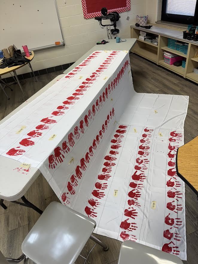 2nd & 3rd Graders at Pleasant Elementary collaborated to make a handprint flag in honor of our Veteran family members and friends. It is hanging on display in the gym/cafeteria.