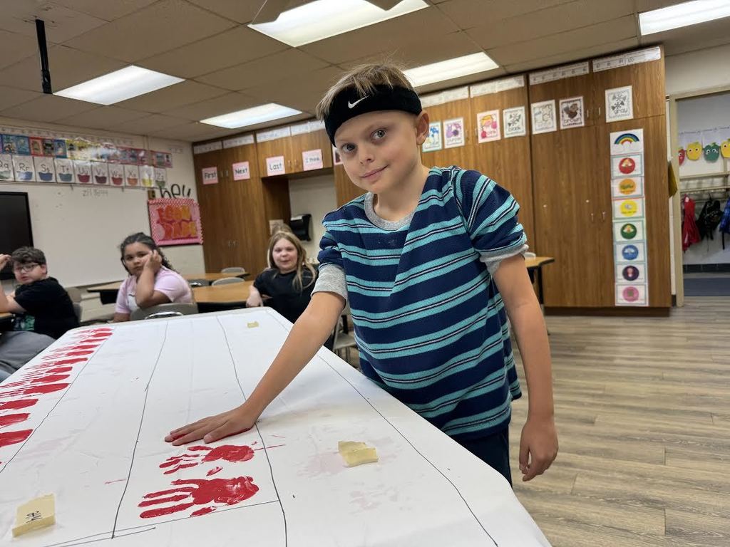 2nd & 3rd Graders at Pleasant Elementary collaborated to make a handprint flag in honor of our Veteran family members and friends. It is hanging on display in the gym/cafeteria.