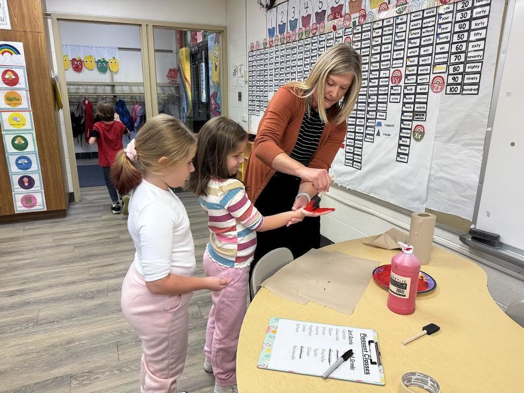 2nd & 3rd Graders at Pleasant Elementary collaborated to make a handprint flag in honor of our Veteran family members and friends. It is hanging on display in the gym/cafeteria.