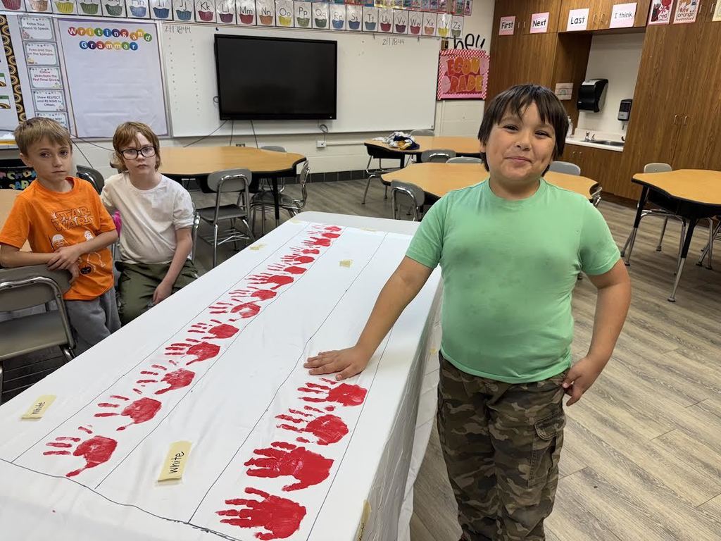 2nd & 3rd Graders at Pleasant Elementary collaborated to make a handprint flag in honor of our Veteran family members and friends. It is hanging on display in the gym/cafeteria.