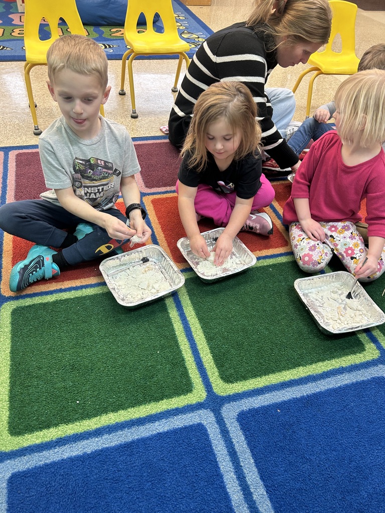 Preschool students from Mrs. Golden and Mrs.Lesch’s class had a guest visitor, Mrs.Jude, come to class and talk about dinosaurs. The first lesson a couple of weeks ago, the students learned the names of dinosaurs, what they ate and how big they really were. She brought  a life size paper foot of a T-Rex and the students each put one shoe inside the foot to see how many shoes it would take to fill it. Fridays lesson enabled them to be paleontologists, each student used a brush and toothpick to dig for dinosaur bones, each student excitedly and successfully found a dinosaur! Thank you to Mrs. Jude for a fun and educational experience. 