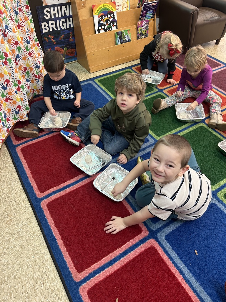 Preschool students from Mrs. Golden and Mrs.Lesch’s class had a guest visitor, Mrs.Jude, come to class and talk about dinosaurs. The first lesson a couple of weeks ago, the students learned the names of dinosaurs, what they ate and how big they really were. She brought  a life size paper foot of a T-Rex and the students each put one shoe inside the foot to see how many shoes it would take to fill it. Fridays lesson enabled them to be paleontologists, each student used a brush and toothpick to dig for dinosaur bones, each student excitedly and successfully found a dinosaur! Thank you to Mrs. Jude for a fun and educational experience. 