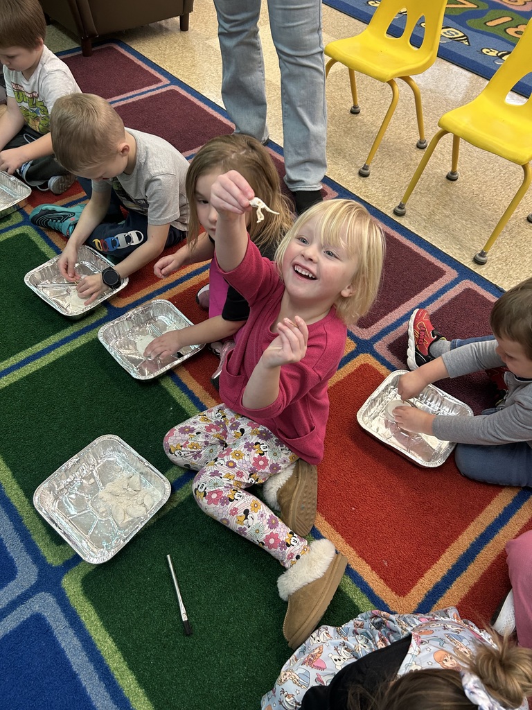 Preschool students from Mrs. Golden and Mrs.Lesch’s class had a guest visitor, Mrs.Jude, come to class and talk about dinosaurs. The first lesson a couple of weeks ago, the students learned the names of dinosaurs, what they ate and how big they really were. She brought  a life size paper foot of a T-Rex and the students each put one shoe inside the foot to see how many shoes it would take to fill it. Fridays lesson enabled them to be paleontologists, each student used a brush and toothpick to dig for dinosaur bones, each student excitedly and successfully found a dinosaur! Thank you to Mrs. Jude for a fun and educational experience. 