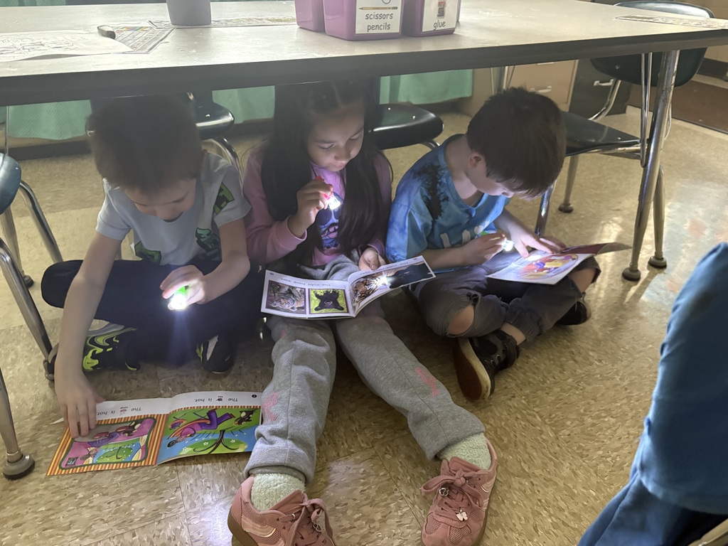 Maplehurst students in Mrs. Caitlyn Cannon's class had a very special reader from Ecuador-Ell assistant Wenddy Riems'  daughter lives there and she writes children's books.  Andrea Rivadeneira wrote the book "Lulu and Ellie:Days of Nerves".  She read this book to the first graders from Ecuador.  Miss Kaitlyn Smith's kindergarten class had a guest reader from Africa-Maddie Roche Anderson, formerly from Norwalk, read to her students on Friday.  She read a story her dad wrote when she was a child. Students had the opportunity to ask questions and learn more about Africa and Ecuador-we are grateful for these amazing opportunities.  Friday was flashlight friday and each student was given a flashlight to use to read "in the dark" in their classrooms.  Miss Kaitlyn Smith's students were caught reading under their desks.