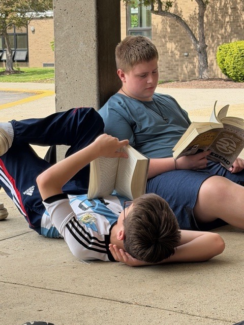 When it’s hot in the building, you take the books outside and read in the shade!! NMS Literature classes